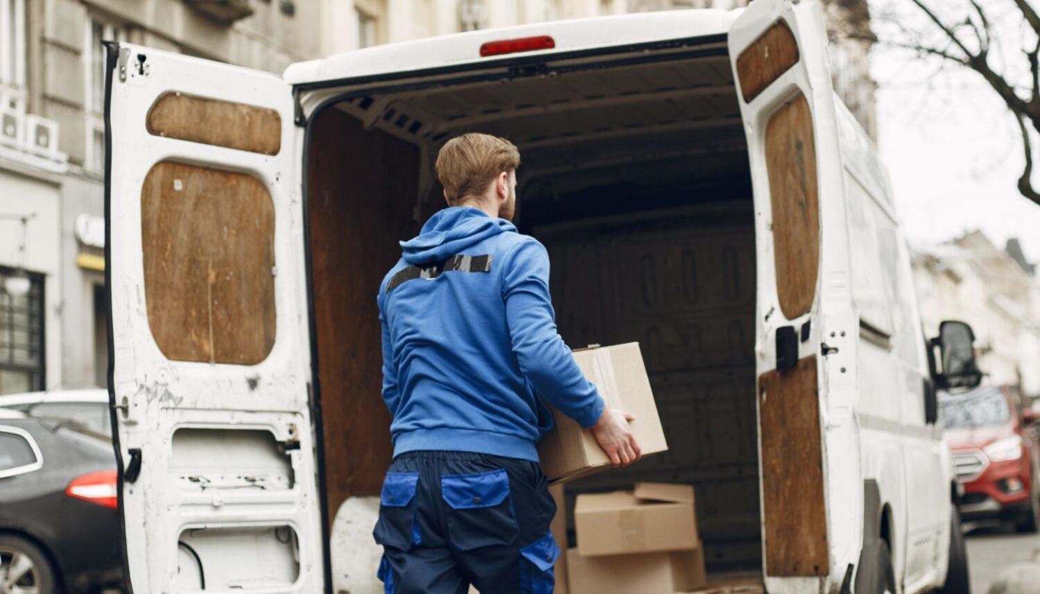 Delivery packages being loaded into vans at an Amazon-style station